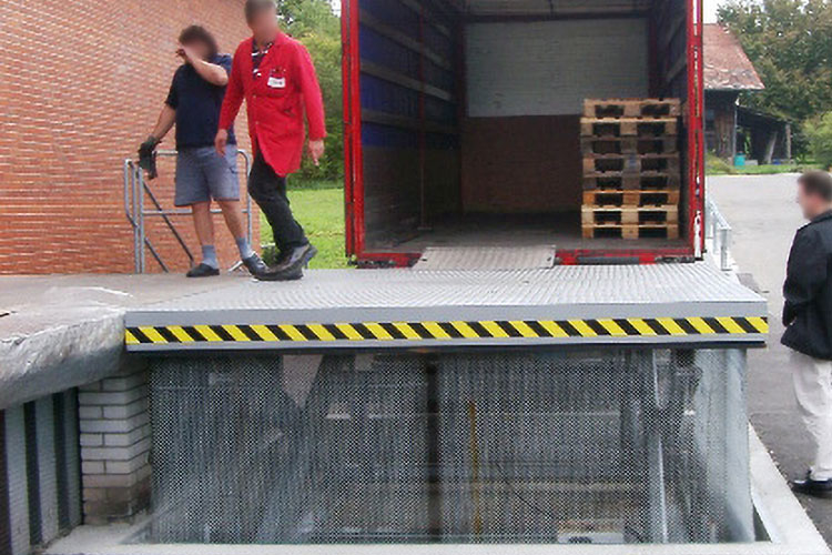 loading lift table in front of red truck