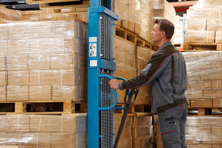 warehouse staff operating high-lift trucks with pallets and packages