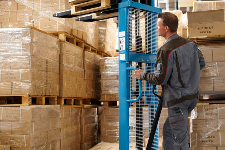 warehouse staff operating high-lift trucks with pallets and packages