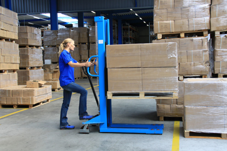 warehouse staff operating high-lift trucks with pallets and packages