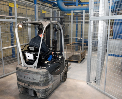 man pushes pallet into grid box