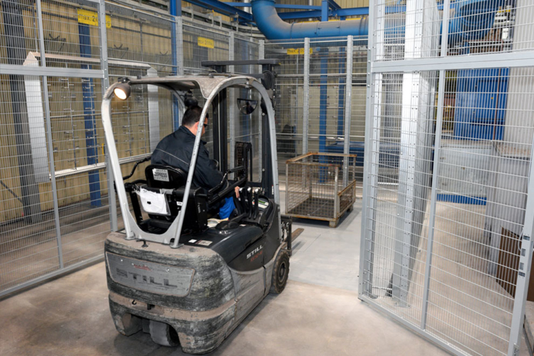 man pushes pallet into grid box